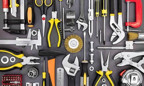 set of hand various work tools on grey background top view including different kinds of wrenches, pliers, clamps, calipers and other